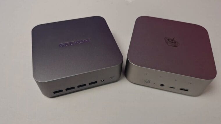 Two mini PCs with USB ports and different logos