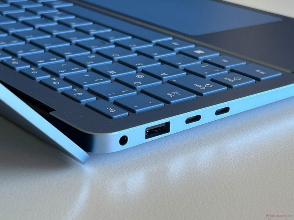 Surface Laptop 7 with keyboard and connection ports, including USB and a headphone jack