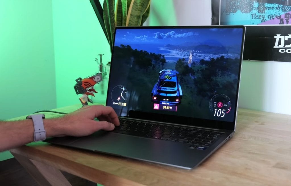 A gamer is playing a racing game on the Samsung Galaxy Book 5 Pro laptop, enjoying high-quality graphics and dynamic gameplay.