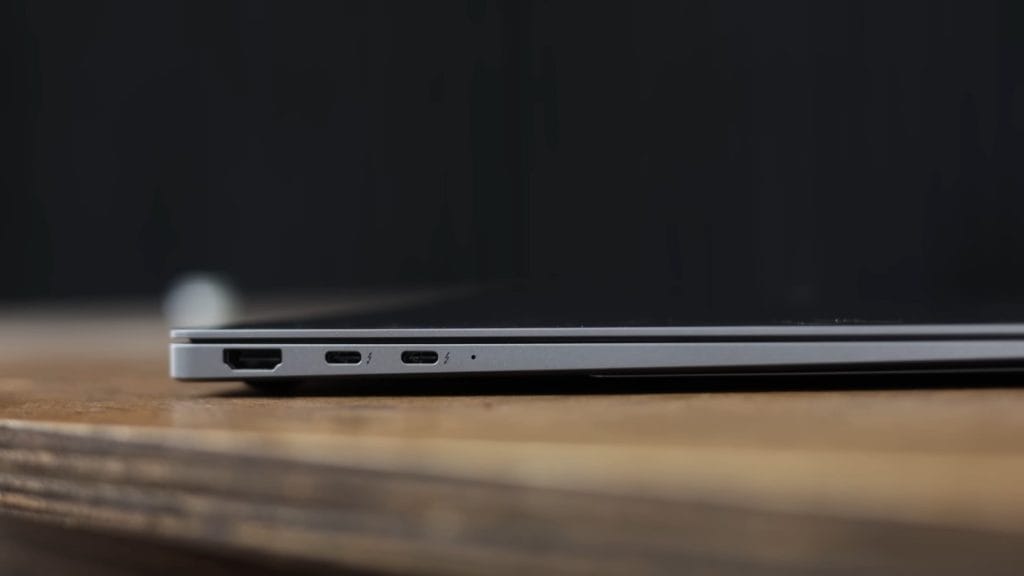 Samsung Galaxy Book 5 Pro with USB-C and HDMI ports on a wooden surface.