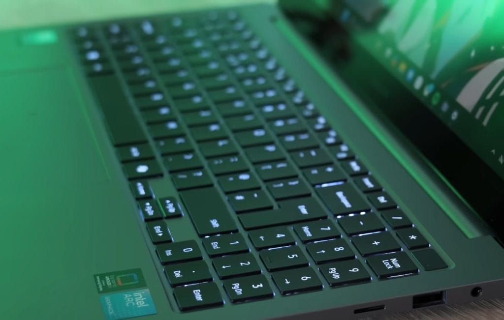 A laptop keyboard with backlighting and display, showcasing technological details.