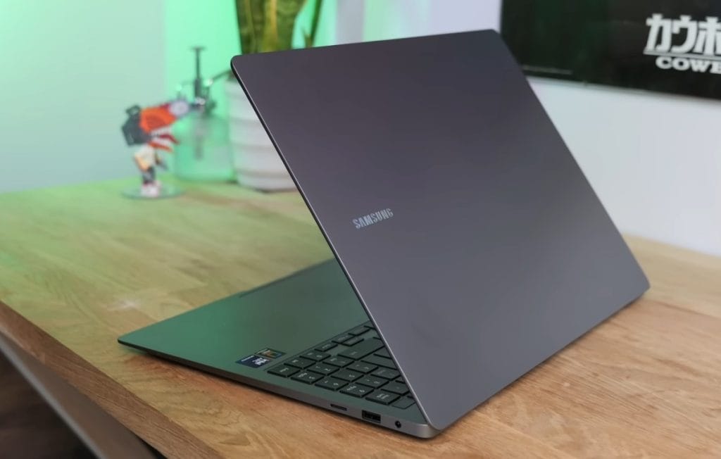 A modern Samsung Galaxy Book 5 Pro laptop on a wooden surface, showcasing its stylish design and connectivity ports.