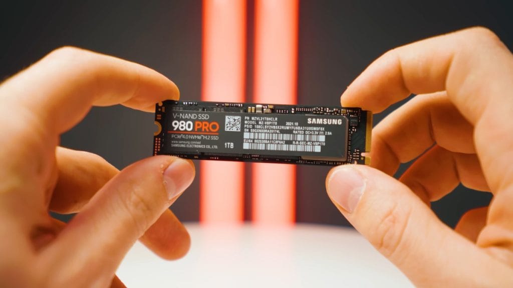 The Samsung 980 PRO V-NAND SSD M.2 drive with 1TB storage, shown in hands.